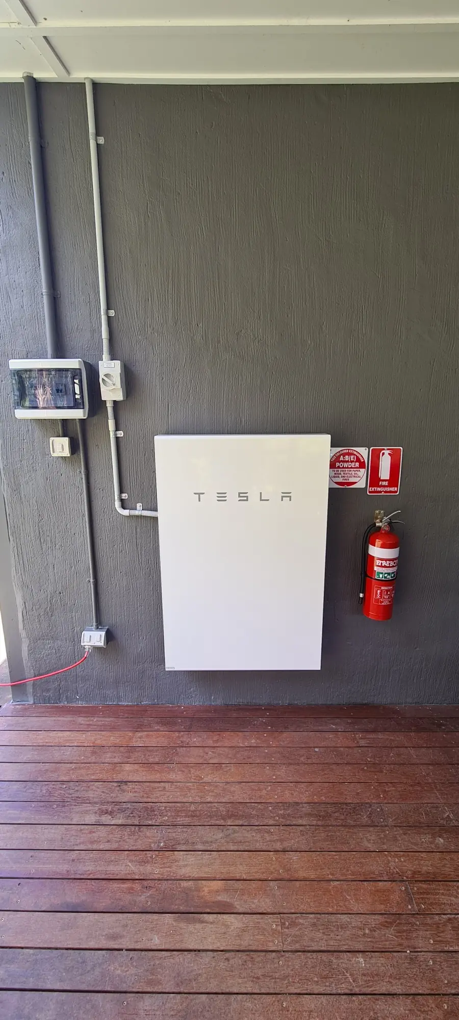 A Tesla Powerwall installed on a garage wall